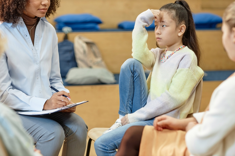 Therapist consulting a young adult on couch