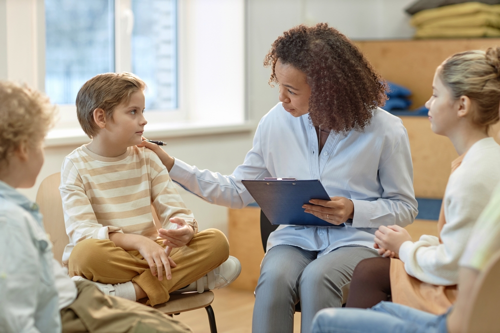 Therapist reviewing behavior charts during an evaluation